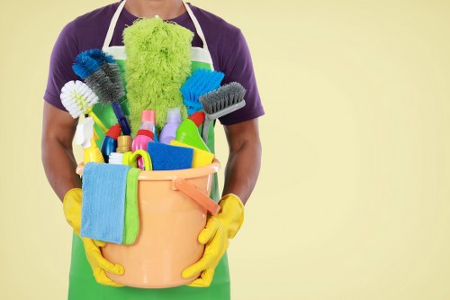 Professional cleaner using approved equipment and warning signage